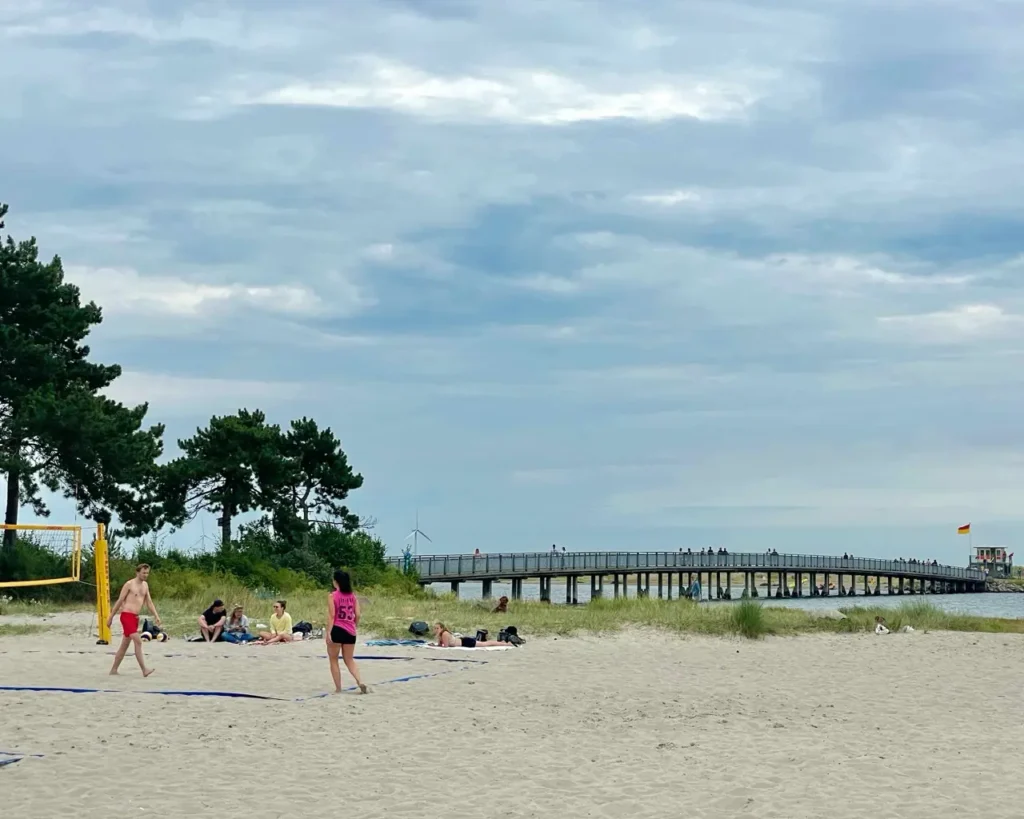 Friends playing volley ball at the Amager beach in Copenhagen