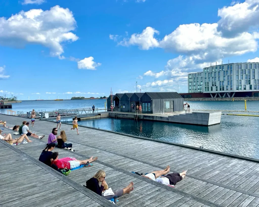 People relaxing and swimming at the Bathzone Sandkaj - free swimming zone in the Copenhagen harbour