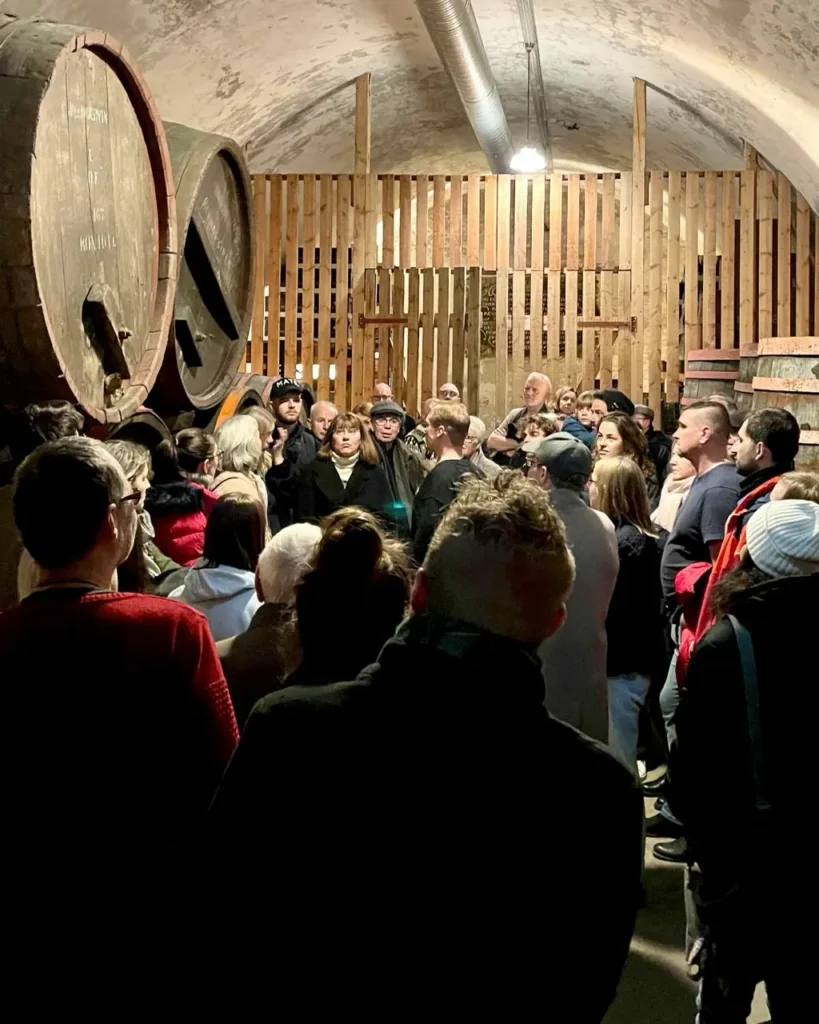 Group of people listening to the guide at the Home of Carlsberg brewery tour