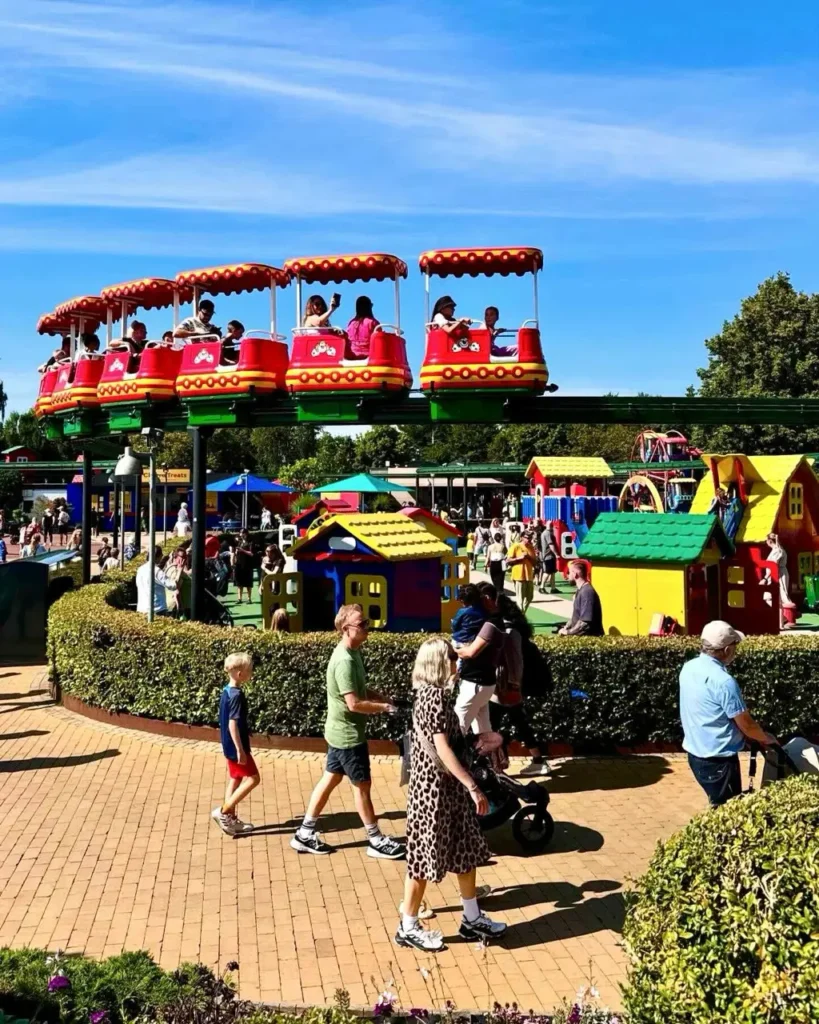 Children and adults enjoying the fun rides at Legoland Billund