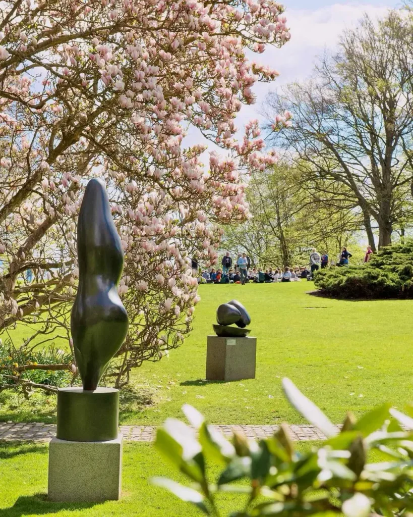 People relaxing at the Louisiania museum of modern art gardens
