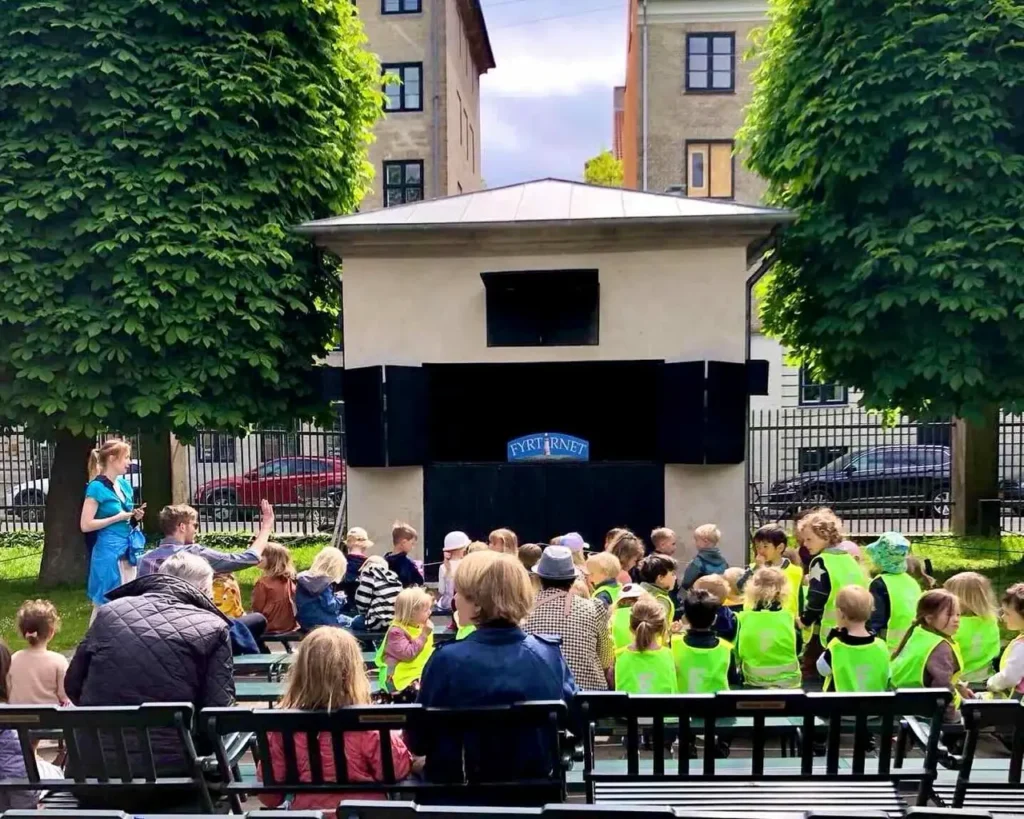 Kids waiting for the puppet show at Marionetteatret theatre in the King's garden