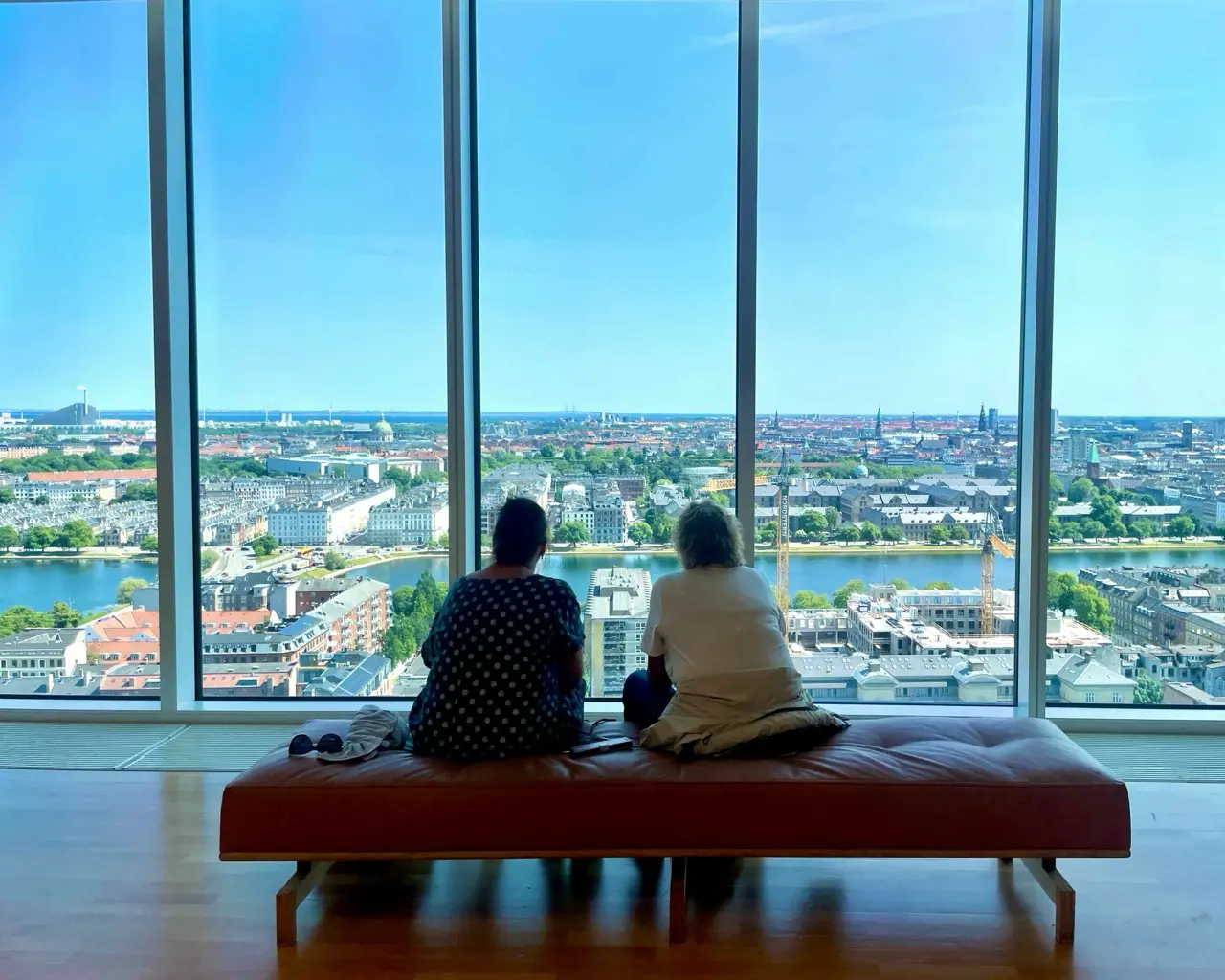 Two ladies admiring the view from one of the Copenhagen hidden gems Mersk Tower viewpoint