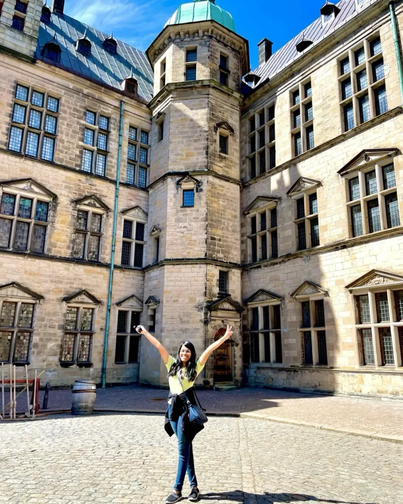 Agalya standing in front of the Kronborg Castle Helsingor