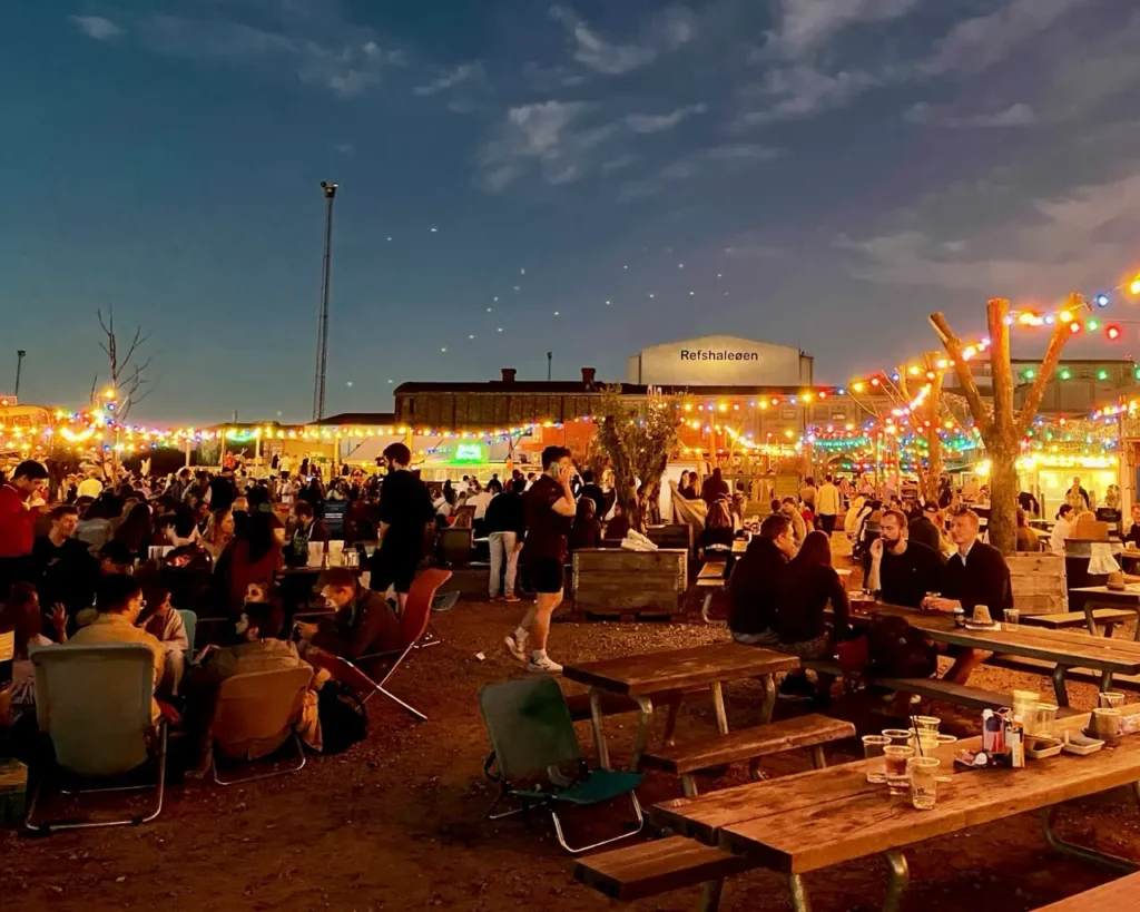 People hanging out at the Reffen street food market at night