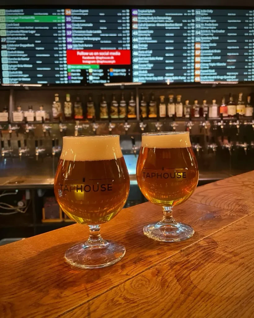 Two tap house beer glassses at the bar