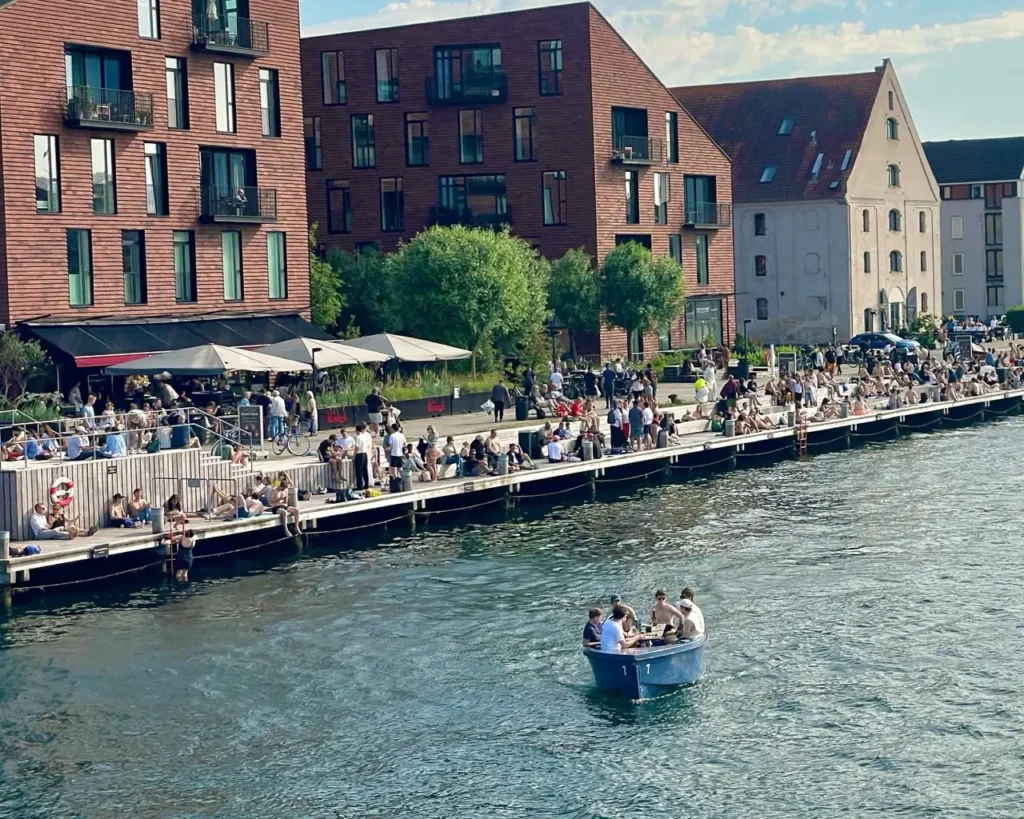 People relaxing by the canals of Copenhagen
