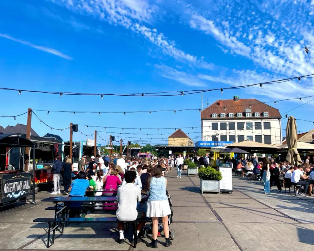 Many people chilling at the Broens Street food market Copenhagen